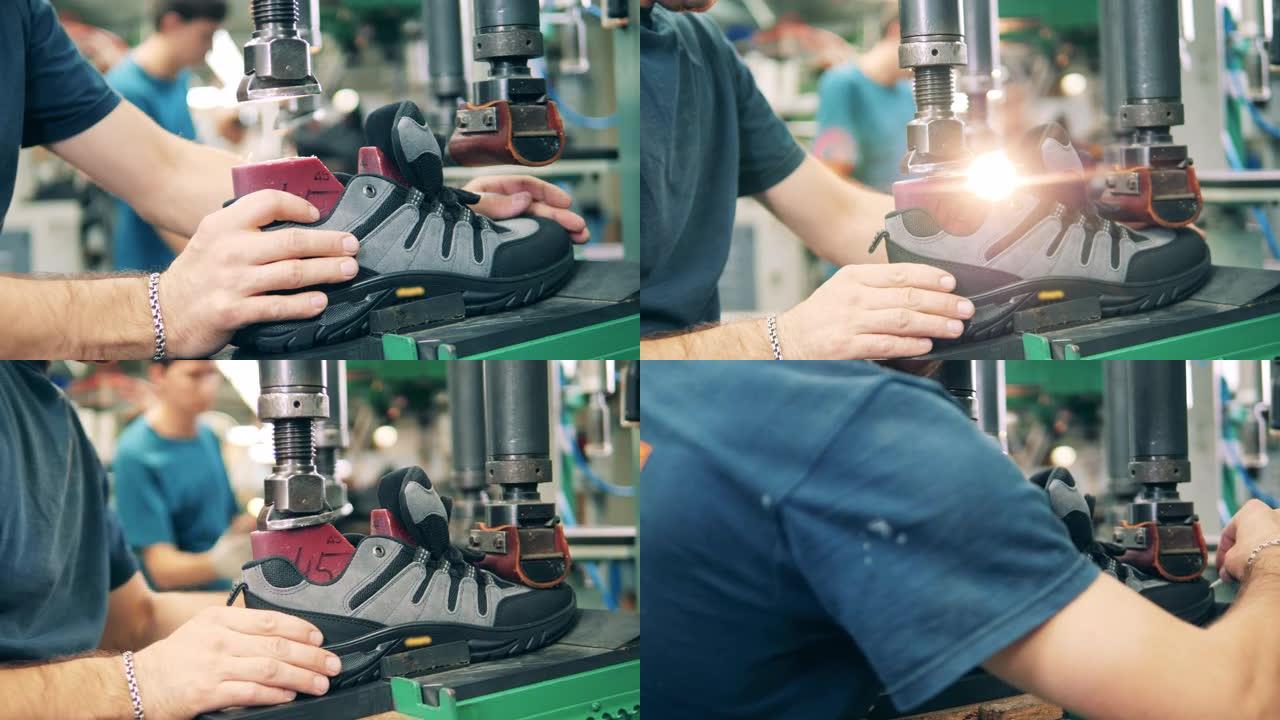 一只靴子正由一名男性工人把它的鞋底组装在一起。制鞋厂。