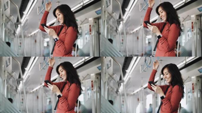 年轻美女在公共交通中使用智能手机