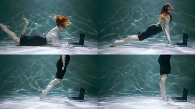电影拍摄，年轻的红发女商人在水下使用笔记本电脑咨询客户，游泳慢动作。