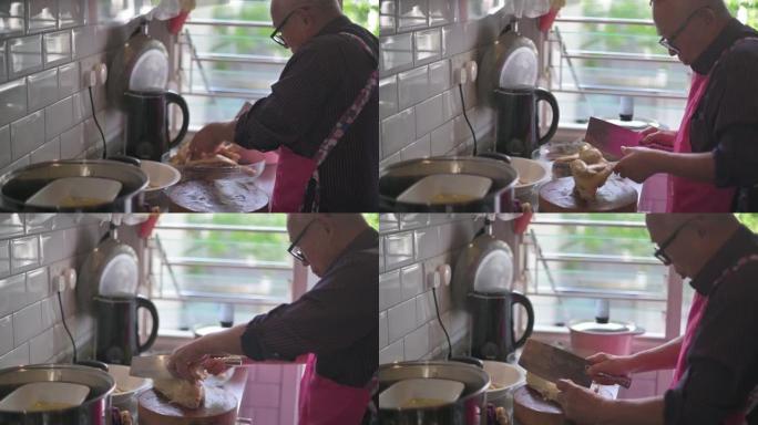 中国老人在厨房砍鸡吃家庭团圆饭春节