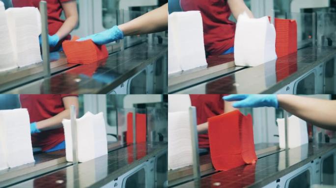 将红色和白色面巾纸放在造纸厂的传送带上