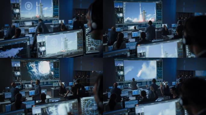 任务控制中心的一群人见证了太空火箭的成功发射。飞行控制员工坐在前面的计算机显示屏上，监视人员的任务。