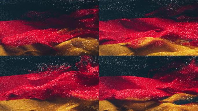 由彩色沙子分解成颗粒制成的德国国旗的完整框架