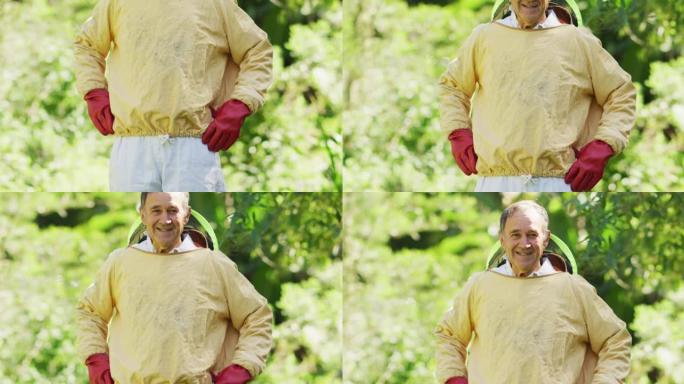 穿着防护服微笑的高加索男性养蜂人的肖像