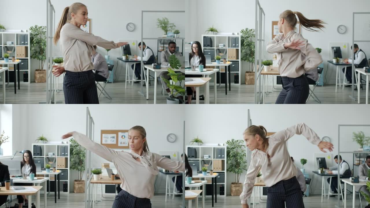 有吸引力的女舞者在办公室表演的慢动作，而商人在背景中工作