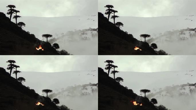 山崖上的篝火，背景是安第斯山脉，阿根廷巴塔哥尼亚，南美。