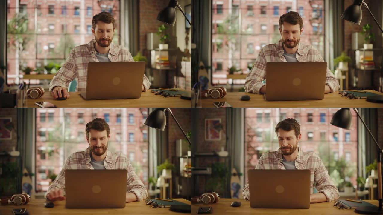 时尚的大胡子年轻成年男子在创意阁楼办公空间使用笔记本电脑。穿着方格衬衫的快乐专家在家远程处理代理项目