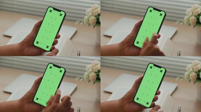 男人在绿屏手机上使用应用程序