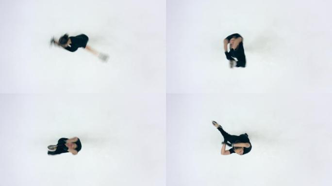 女溜冰者在溜冰场上旋转的俯视图