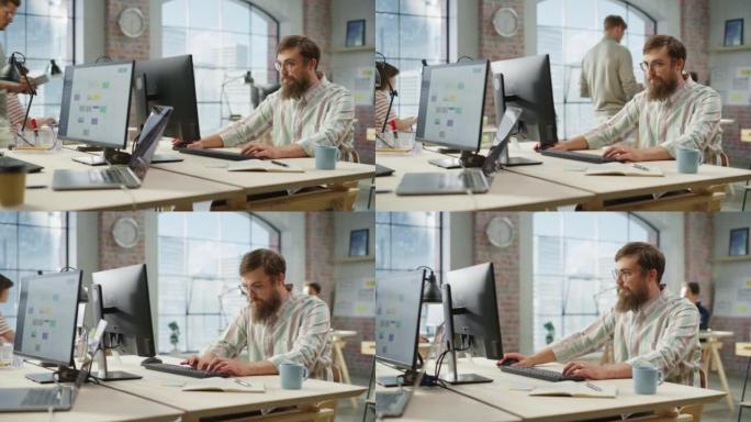 在明亮宽敞的办公室中使用计算机时，用眼镜聚焦的有创意的大胡子白人肖像。营销经理构建新战略。多莉开枪了