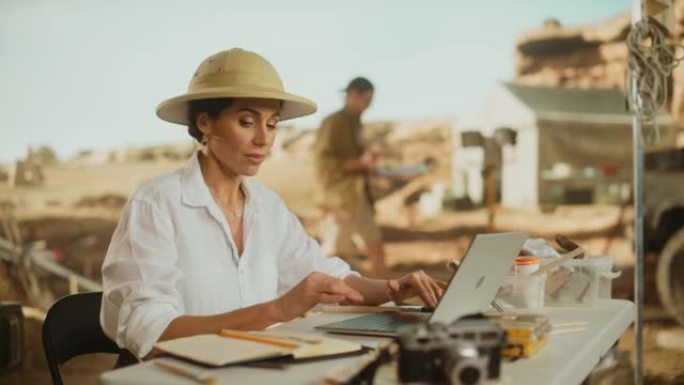 考古挖掘地点: 伟大的女性考古学家进行研究，撰写观察，使用笔记本电脑，分析化石遗迹，古代文明文化文物