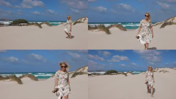 意大利撒丁岛，一个金发女人在海滩上散步的景色。