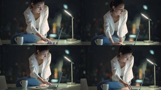 亚洲年轻女商人在夜间使用笔记本电脑工作