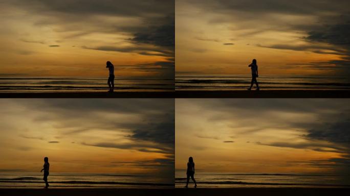 走在沙滩上的剪影孤独寂寞海边散步傍晚晚霞
