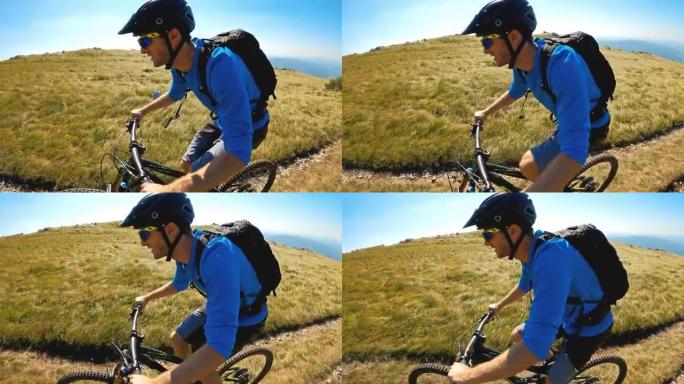 开朗的男性山地自行车，在雄伟的山坡上踩踏板