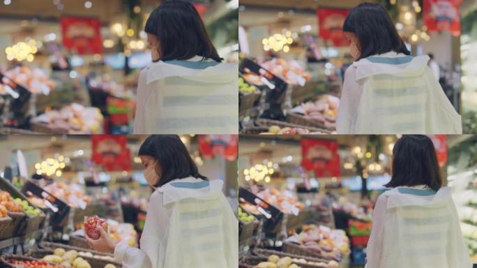 亚洲妇女在超级市场购物新鲜蔬菜