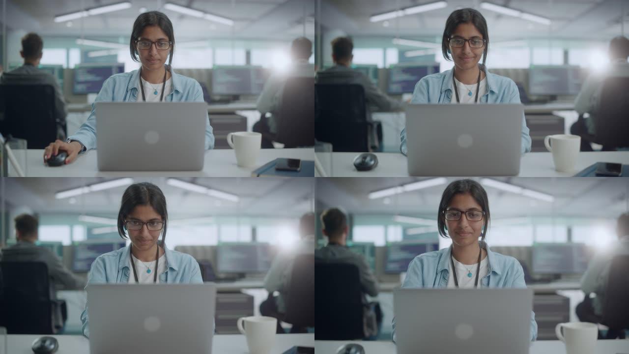 多元化的办公室: 微笑的印度IT程序员在台式计算机上工作的肖像。女专家创造创新软件。专业工程师开发应