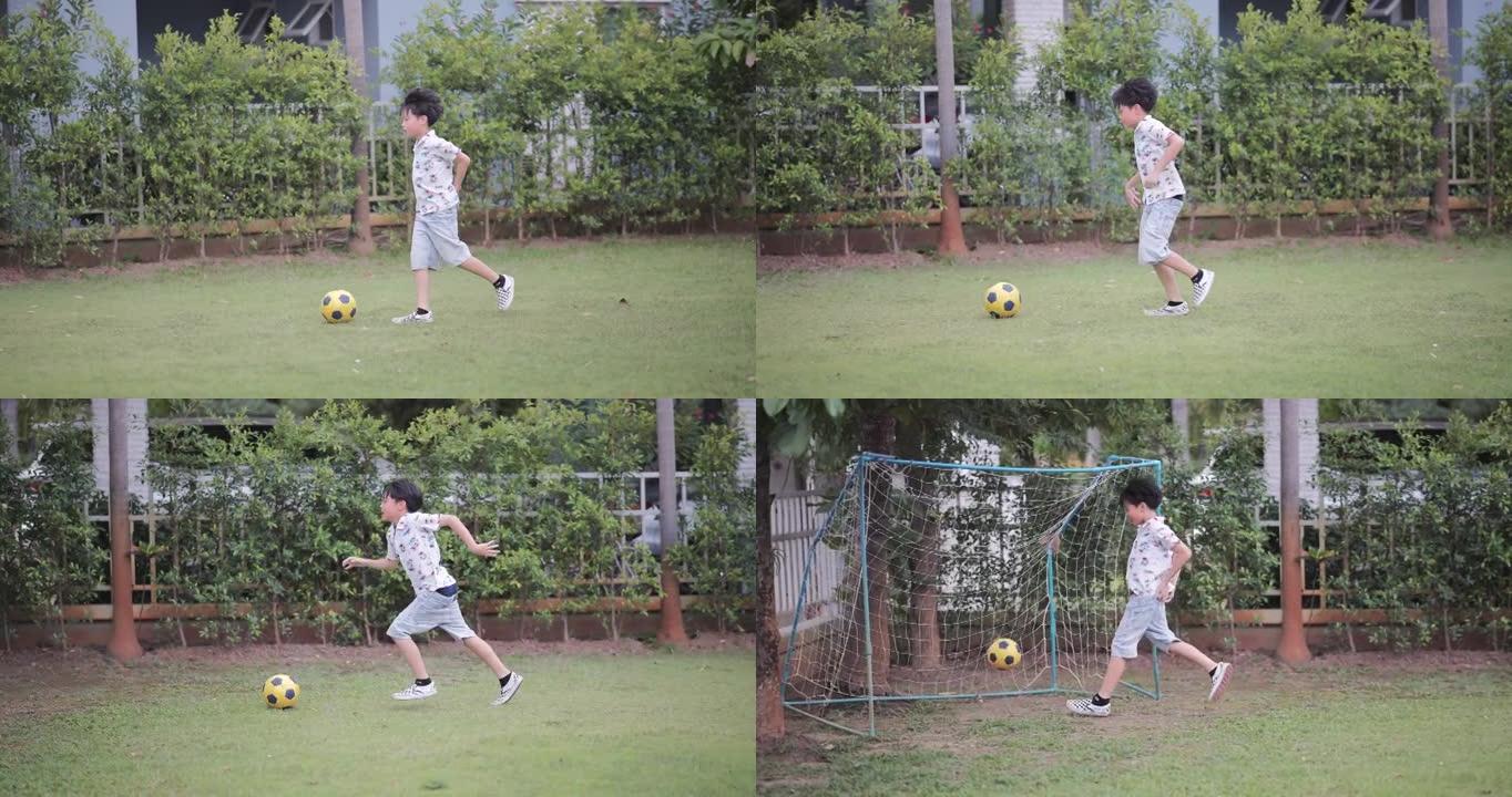 亚洲男孩在公园踢足球