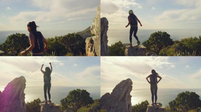 年轻女子用复制空间庆祝到达山顶。适合运动的女性兴奋地从上面欣赏风景，举起手臂，在岩石景观上欢呼，在边