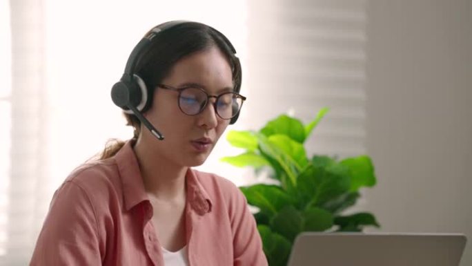 年轻的呼叫接线员女商人在笔记本电脑上与网络摄像头通话，远程远程聊天