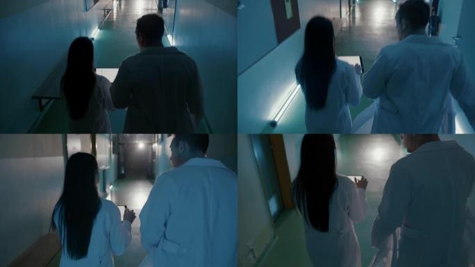 SLO MO两名ER医生在冲下医院走廊时看着数字平板电脑