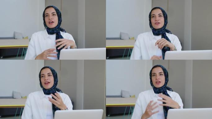 中东女商人在创业办公室的一次会议上戴着头巾说话