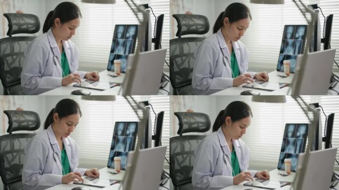 医生在办公桌上在数字平板电脑上输入Rx处方