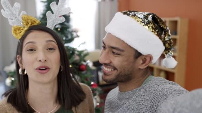 一对年轻夫妇在家一起制作有趣的圣诞问候视频的4k肖像视频