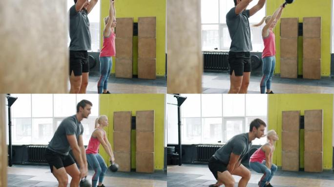 男女在运动健身房蹲下举重集中锻炼