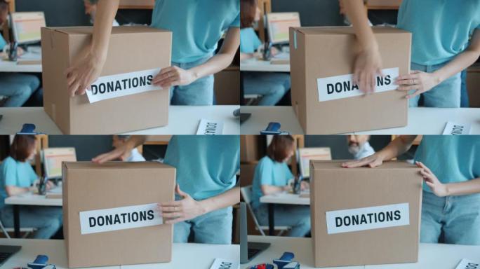 慈善组织将捐赠标签贴在纸箱上的特写