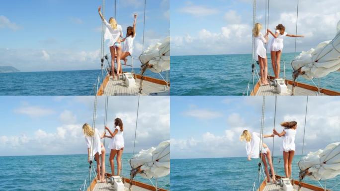 兴奋的年轻朋友在意大利的远洋航行中庆祝坐在船上。两个快乐的女人一起度假，在意大利海洋上巡游的船上庆祝