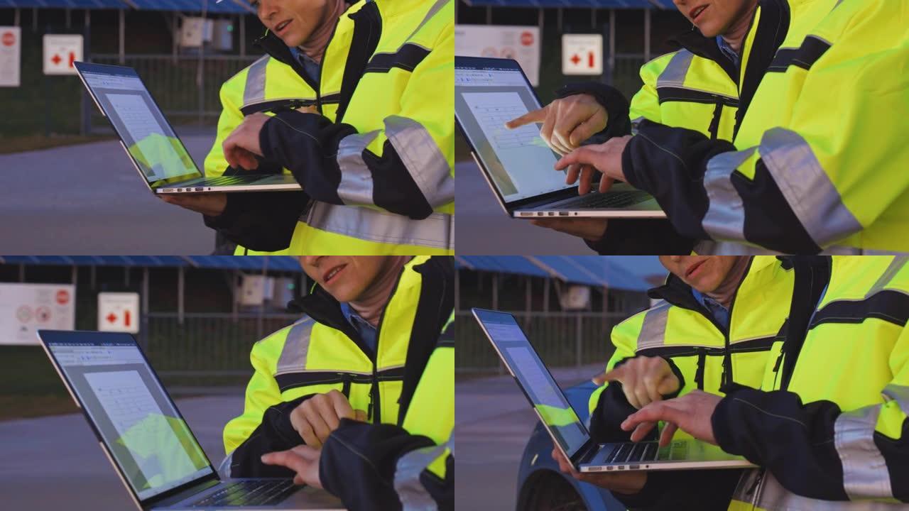 SLO MO现场工程师使用笔记本电脑在黄昏时检查光伏电站的运行情况