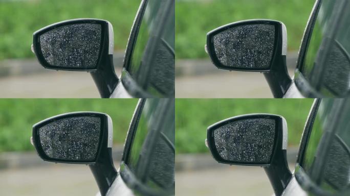 雨水落在汽车的镜子上