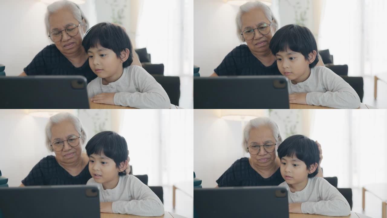 奶奶和孙子在家一起做作业。