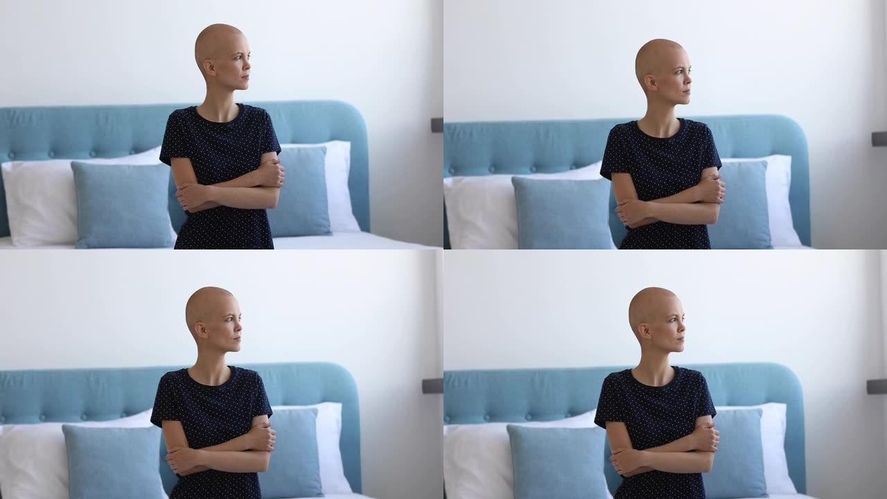 女性癌症患者坐在床上看着窗外