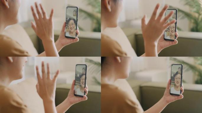年轻女子在智能手机上与年长的母亲进行视频通话的特写镜头