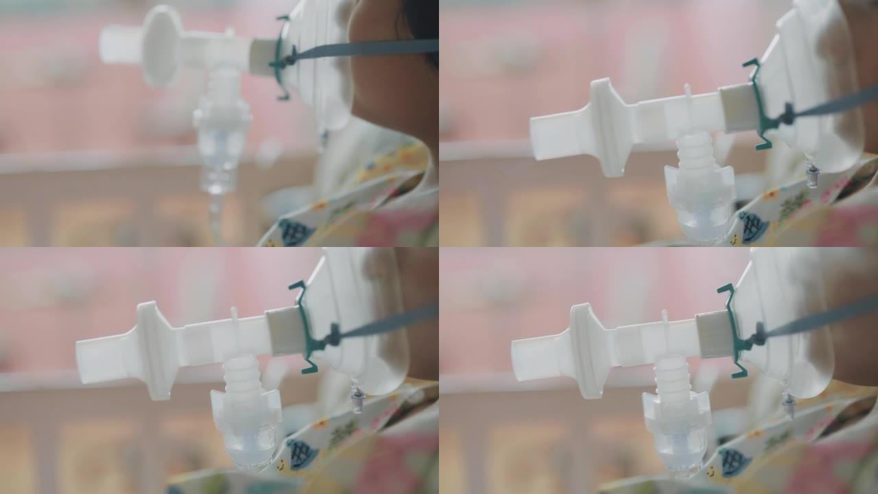 亚洲男孩使用雾化器缓解咳嗽