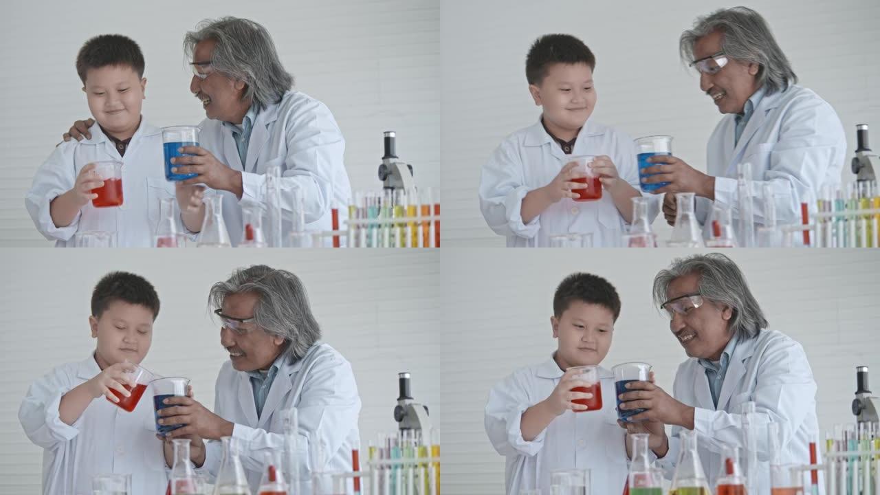 可爱的男孩与高级老师进行科学实验