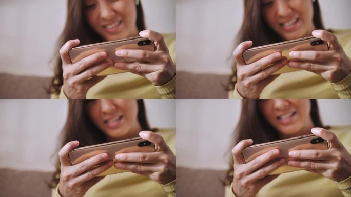 亚洲女人在家玩智能手机游戏