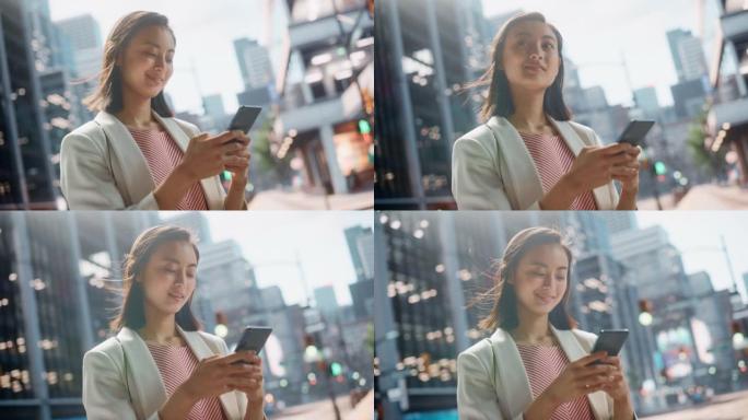 一位美丽的日本女性穿着时髦的休闲服，在城市街道上使用智能手机的肖像。大城市的经理与人们在线联系，消息