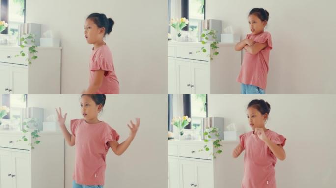 亚洲蹒跚学步的小女孩女儿与母亲的影响者使用智能手机录制视频跳舞一起在家里的客厅开心快乐。