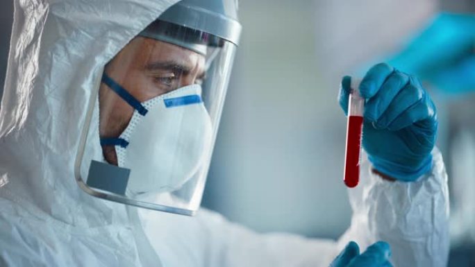 医学实验室药物开发: 研究科学家穿着工作服，手术手套，面罩和防护罩，用血液固定试管，检查和分析样品。