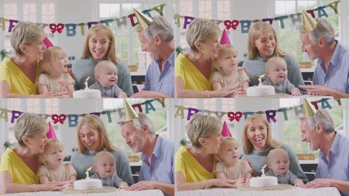 祖父母和母亲在家里的第一个生日聚会上给孙子唱生日快乐