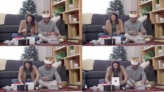 4k视频片段，一对年轻夫妇坐在休息室地板上，在家中一起包装圣诞节礼物