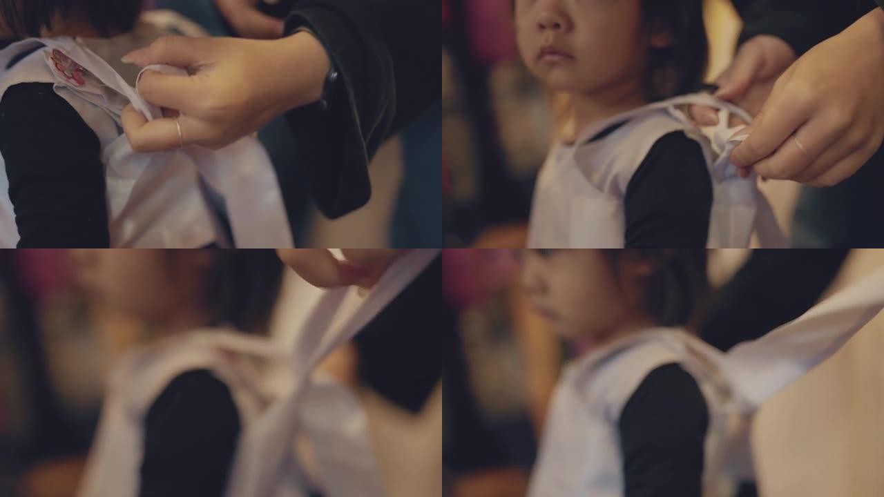 一个可爱的小女孩的特写镜头正穿着她传统的韩国服装做准备。