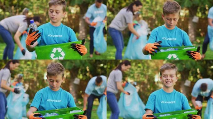 微笑的高加索儿子在户外拿着回收板条箱，与父母一起收集塑料垃圾