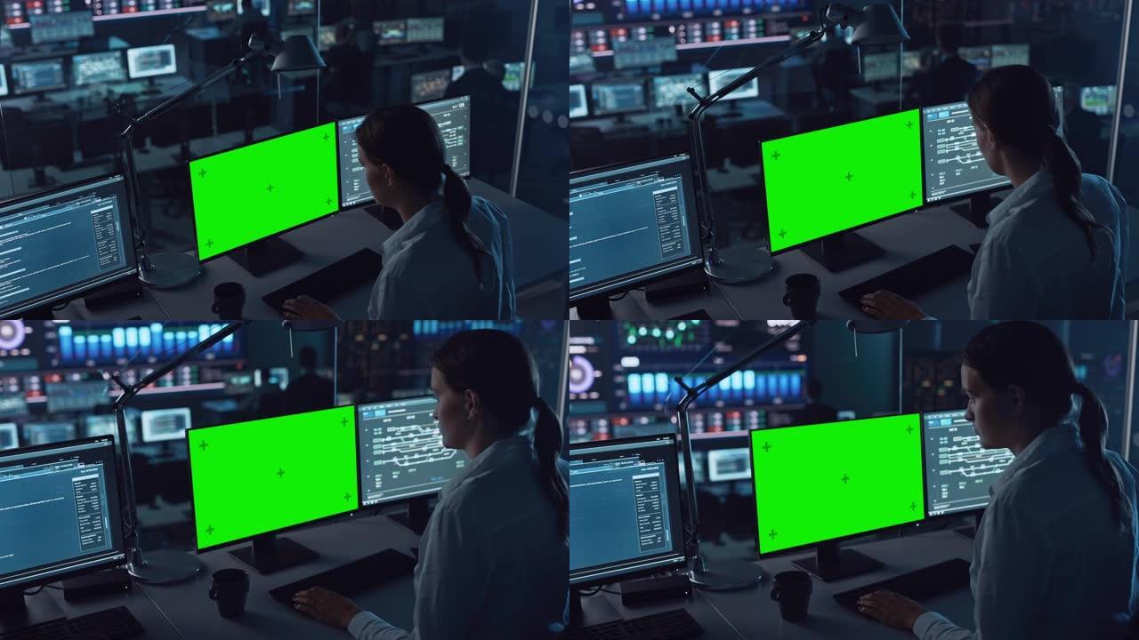 在现代监控办公室工作的女软件工程师，计算机显示屏上的绿屏模型。监控室大数据科学家和管理人员坐在电脑前