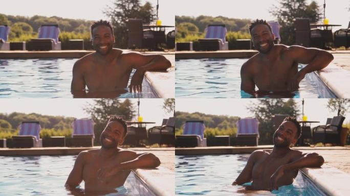 暑假或假期在游泳池放松的微笑男子的肖像