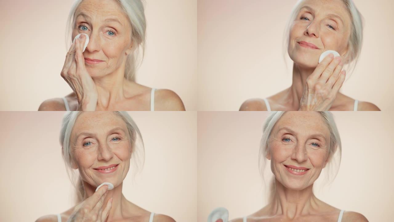 中等Potrait: 美丽的高级女人用棉绒垫清洁她完美的化妆品脸。面带微笑的老妇人，皮肤柔软。优雅的