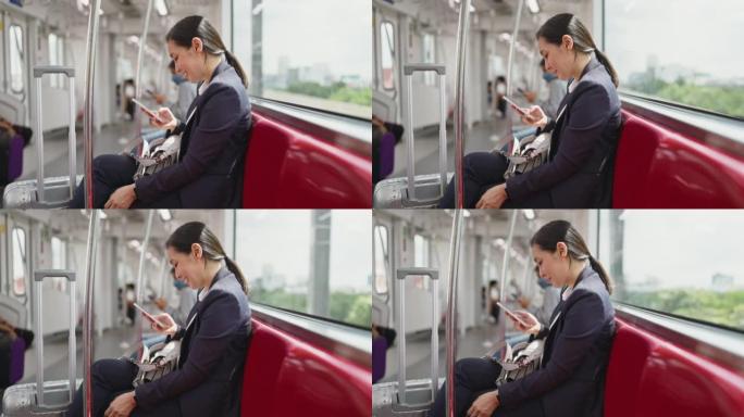 在地铁上使用智能手机的女商人